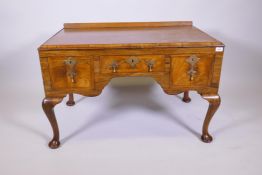 A C19th walnut low boy with cross banded top and three crossbanded drawers with brass drop handles