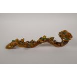A Chinese Sancai glazed porcelain ruyi with applied peach tree and bat decoration, 12½" long