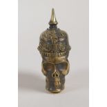 A brass vesta case in the form of a skull wearing a German spiked helmet from WWI, 2½"