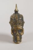 A brass vesta case in the form of a skull wearing a German spiked helmet from WWI, 2½"