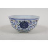 A Chinese polychrome porcelain rice bowl with scrolling lotus flower decoration, early C20th,