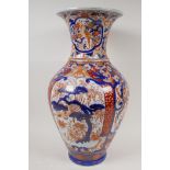 A C19th Imari porcelain vase painted with traditional patterns in bright enamels, 19" high