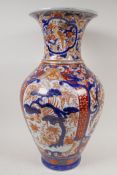 A C19th Imari porcelain vase painted with traditional patterns in bright enamels, 19" high