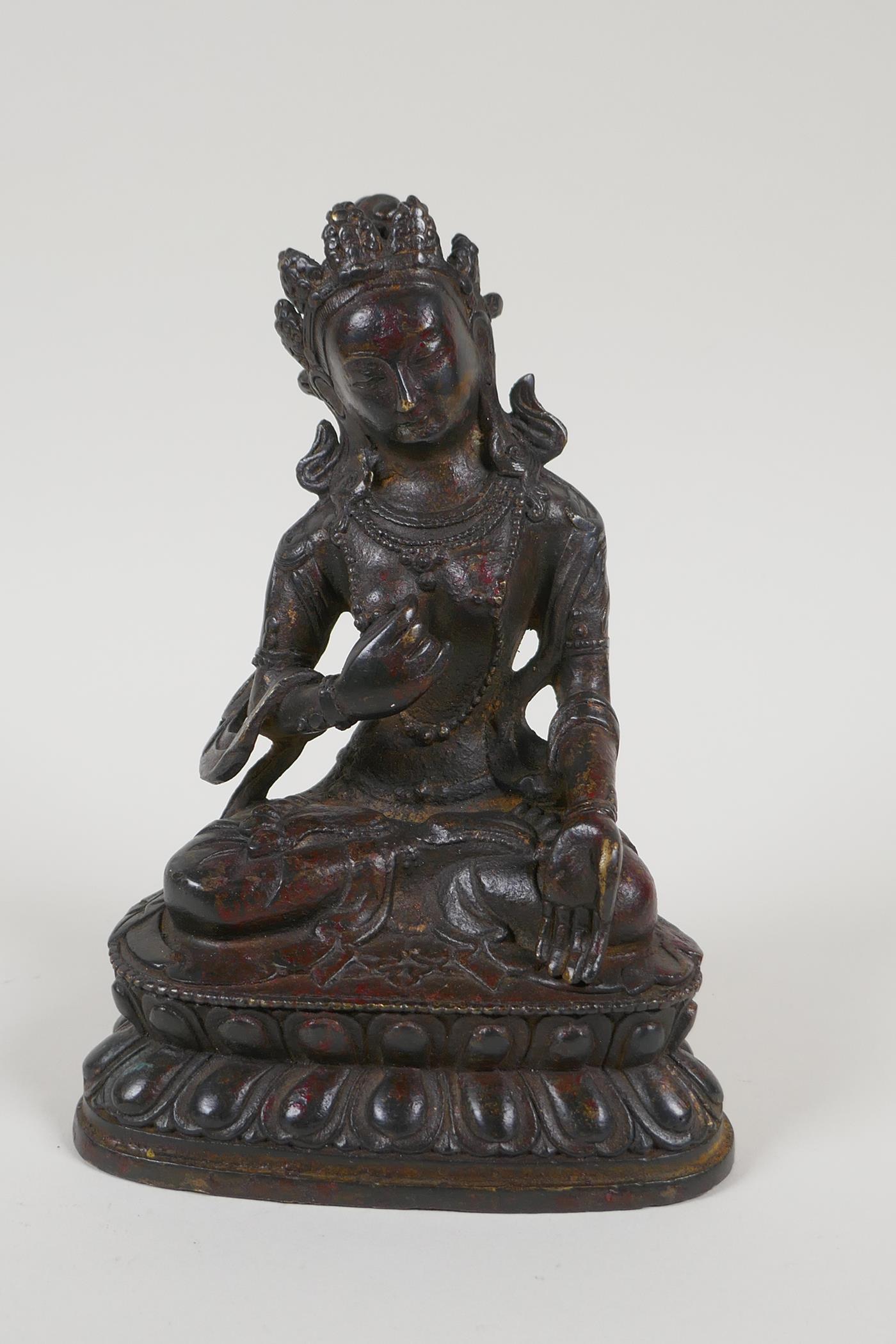 A Sino Tibetan bronze figure of a goddess seated on a lotus throne, 6½" high - Image 2 of 6