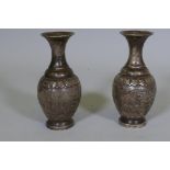 A pair of Chinese white metal vases with raised decoration depicting a lion chasing a deer, seal