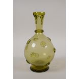 An antique yellow glass vase with decorative stars and drip decoration, 8" high