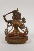 A Sino Tibetan gilt and coppered bronze Buddha seated in meditation, 8" high