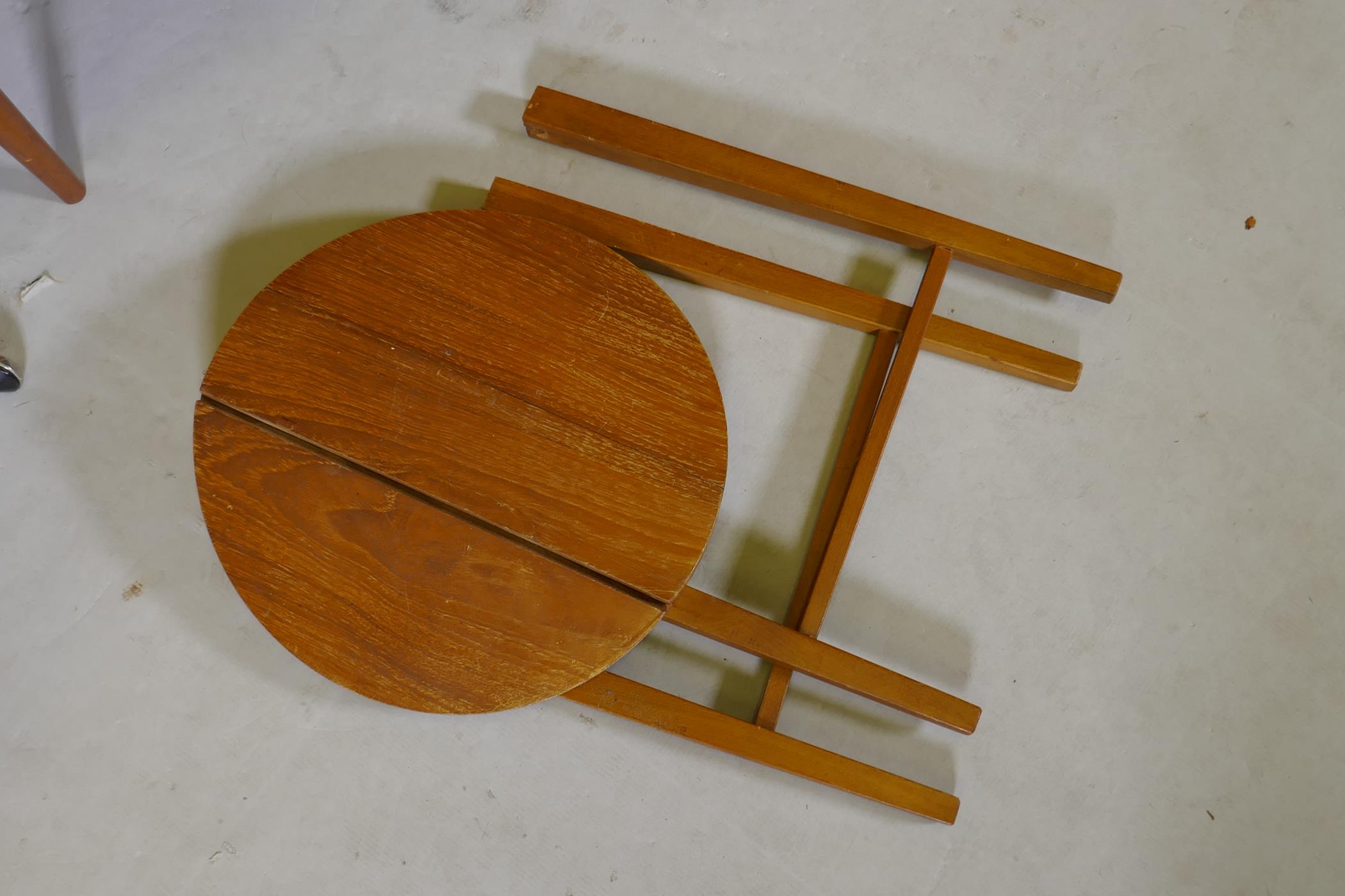 A 1970s teak side cabinet with three drawers and cupboard, and a nest of circular topped - Image 3 of 4