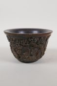 A Chinese faux horn libation cup, with raised decoration of figures in a landscape, 5" diameter