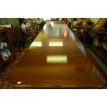 A Regency style mahogany four pedestal dining table with three extra leaves, the solid top with