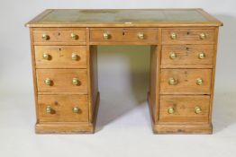 A Victorian pine nine drawer pedestal desk with leather inset top, 48" x  27", 30" high