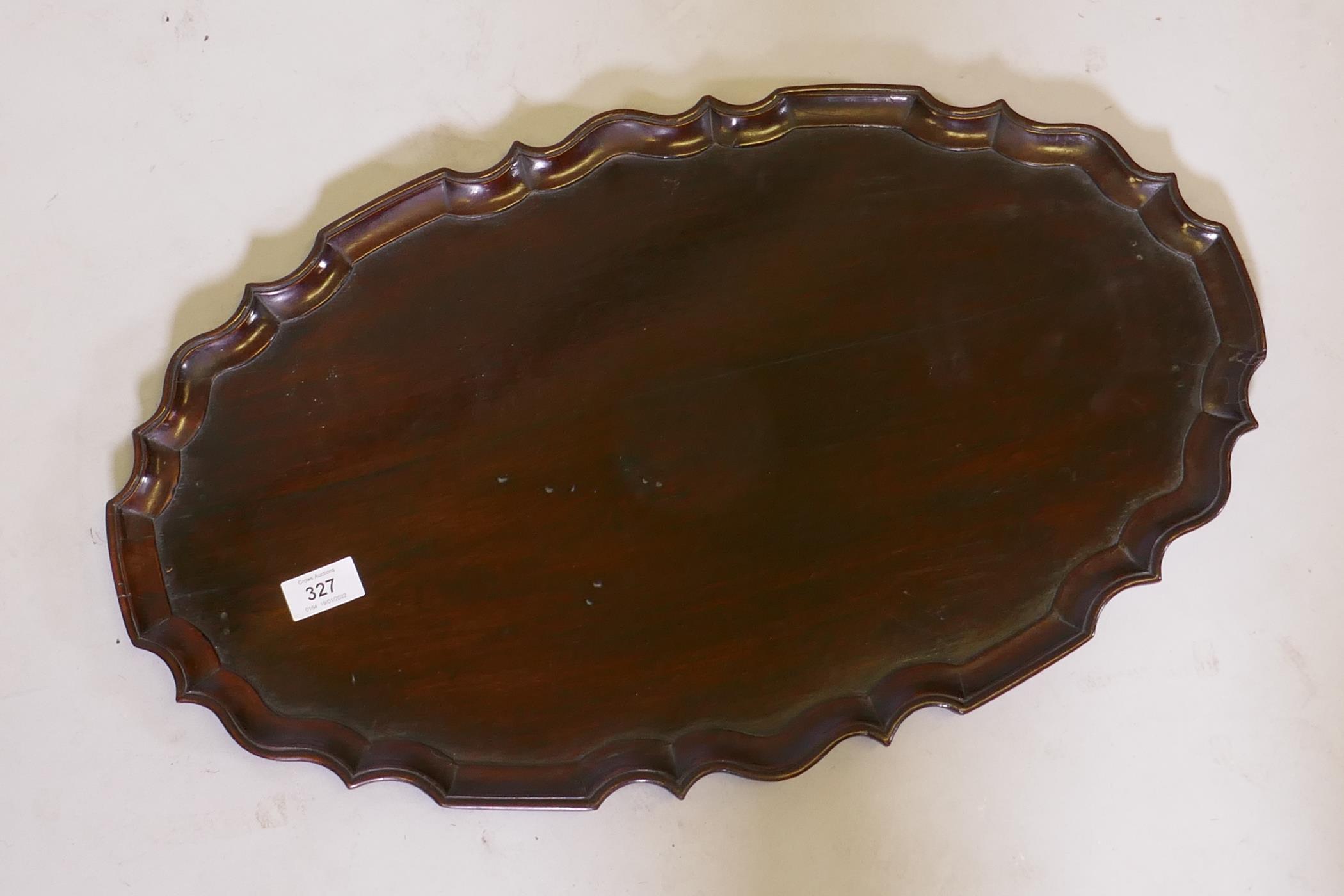 An antique mahogany tray with pie crust edge, 24" x 14"