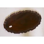 An antique mahogany tray with pie crust edge, 24" x 14"