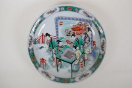 A famille vert porcelain charger decorated with women playing go, Chinese KangXi mark to the base,