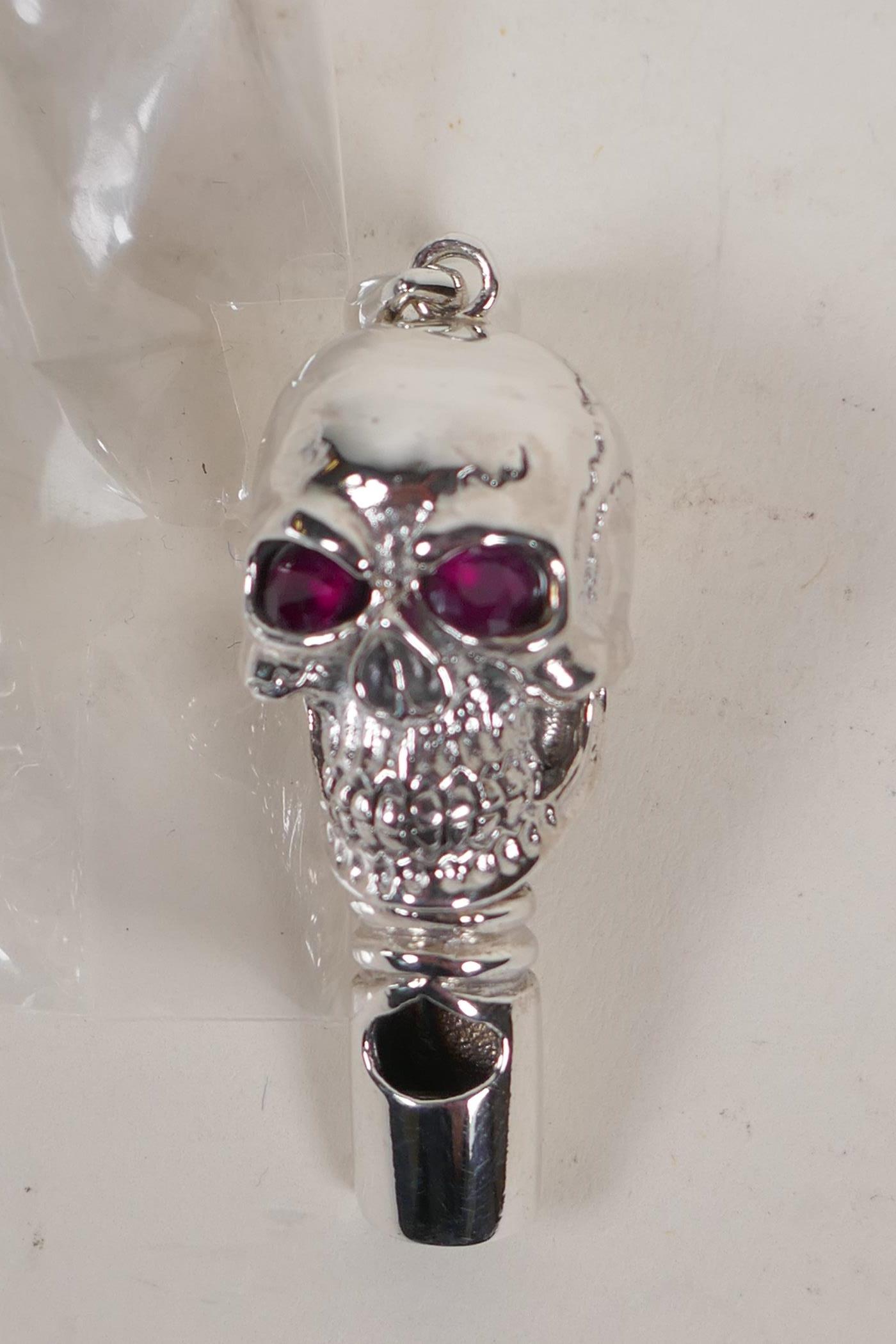 A sterling silver whistle modelled as a skull with ruby eyes - Image 3 of 4