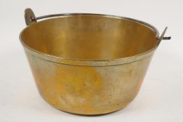 A C19th brass jam pan with iron swing handle, 10" diameter