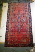 A terracotta and blue ground Persian Hamadan village rug, AF repair, 116" x 61"