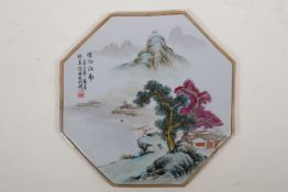 A Chinese polychrome porcelain plaque of octagonal form, decorated with a riverside landscape, 10" x