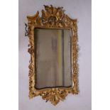 An C18th Georgian giltwood pier glass, the frame with carved and pierced decoration and crest, by
