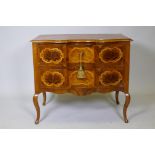 A continental inlaid walnut commode, with shaped top and two drawers, raised on cabriole supports