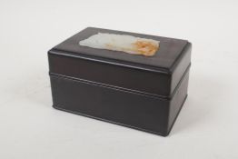 A Chinese hardwood box, the cover with an inset jade carving of dragons, 6" x 4", 3" high