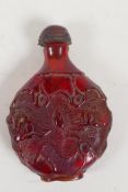 An oriental faux amber snuff bottle with leaf and vine decoration, 3" high