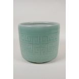 A Chinese  celadon glazed porcelain planter raised on tripod supports, with underglaze archaic style