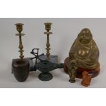 A brass figure of Buddha seated in meditation on a turned wood base, 7" high, an oriental metal