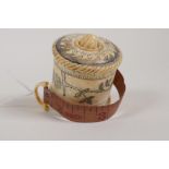 A carved bone tape measure with floral decoration, 2"