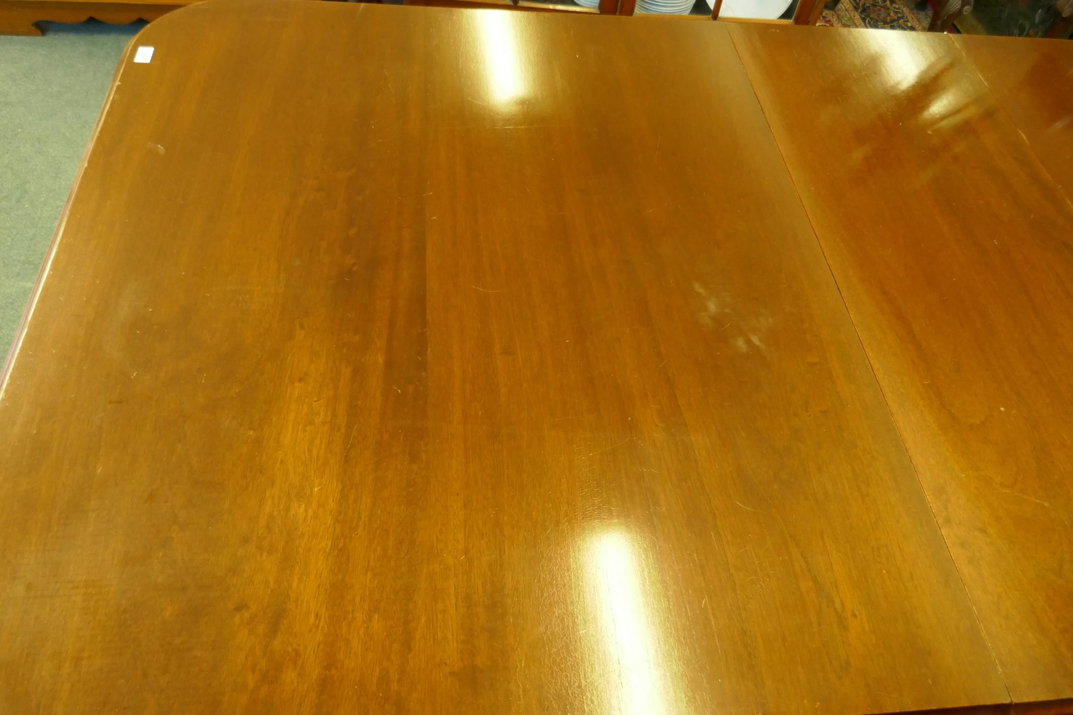 A Regency style mahogany four pedestal dining table with three extra leaves, the solid top with - Image 7 of 9