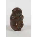 A Japanese bronze okimono incense stick holder in the form of a monkey, impressed mark to base,