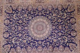 A blue ground Kashmir rug with a floral shabaz medallion design, 74" x 54"