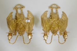 A pair of gilt brass two branch wall sconces in the form of hanging bats, 13" long