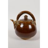 A Chinese treacle glazed porcelain teapot, the handle in the form of a dragon, 5" high