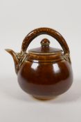 A Chinese treacle glazed porcelain teapot, the handle in the form of a dragon, 5" high