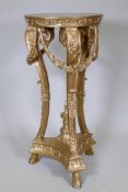 A gilt composition stand with inset marble top and classical style decoration of garlands and urn,