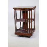 A mahogany revolving bookcase, with inlaid and crossbanded shaped top, late C19th/early C20th, 20" x