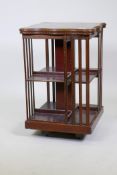 A mahogany revolving bookcase, with inlaid and crossbanded shaped top, late C19th/early C20th, 20" x