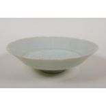 A Chinese song style celadon glazed porcelain dish with a shaped rim and incised lotus flower