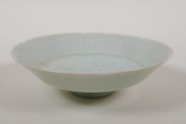 A Chinese song style celadon glazed porcelain dish with a shaped rim and incised lotus flower