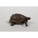 A Japanese bronze Jizai style okimono tortoise with an articulated head and tail, impressed mark to