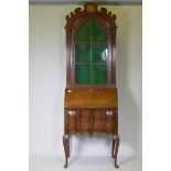 A Georgian style walnut fall front bureau bookcase, the upper section with dome top and fret