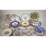 A quantity of decorative pottery and porcelain plates serving dishes and tea pots, to include