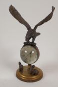 A bronze and glass ball desk clock surmounted by an eagle, 8" high