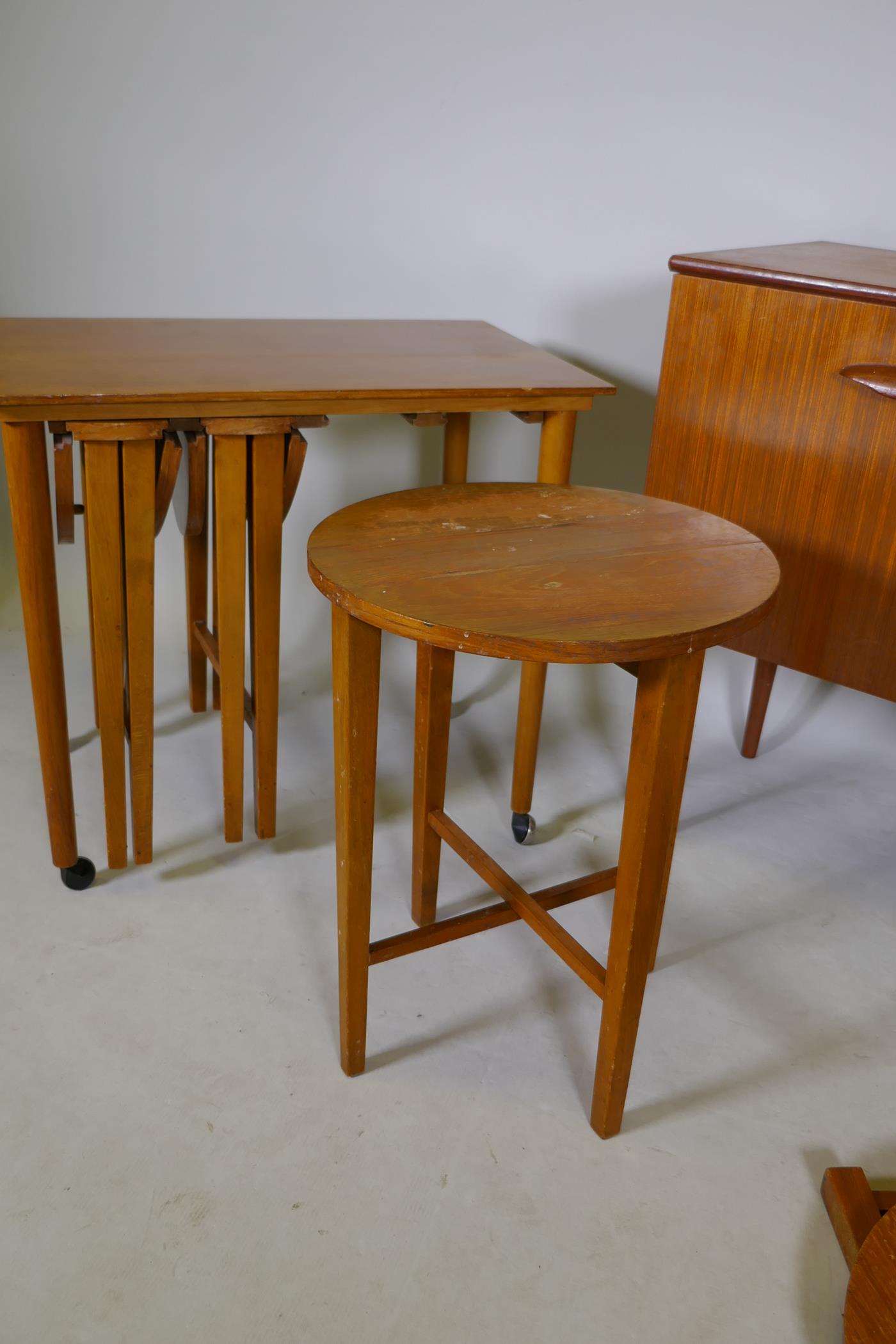 A 1970s teak side cabinet with three drawers and cupboard, and a nest of circular topped - Image 4 of 4