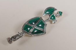 A Scottish style silver and malachite brooch in the form of an axe and shield, 2" long