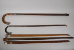 Four late C19th/early C20th hallmarked silver mounted walking sticks, and another, longest 32"