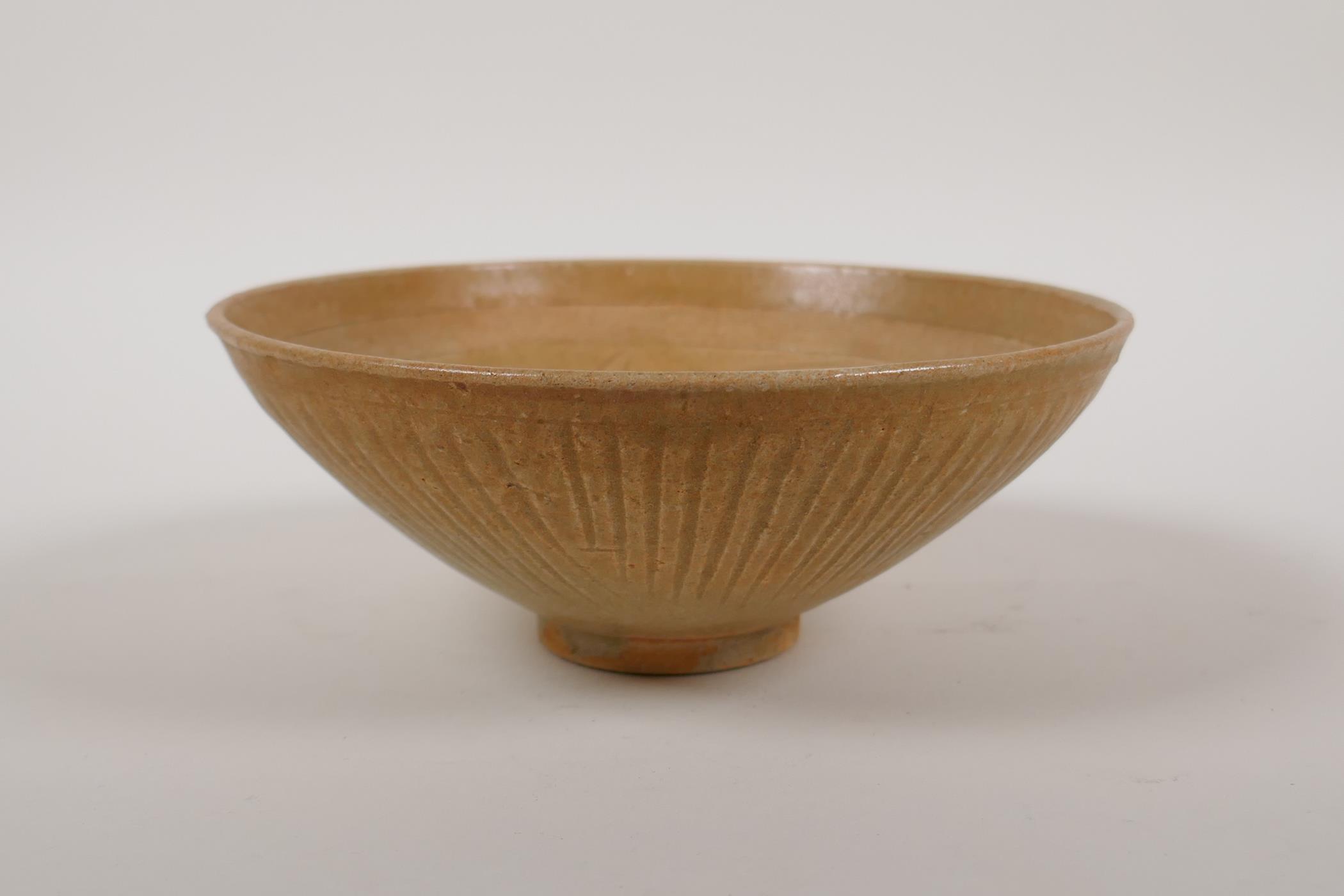 A Chinese song style pottery dish with a thin celadon glaze and incised decorative pattern, 6"