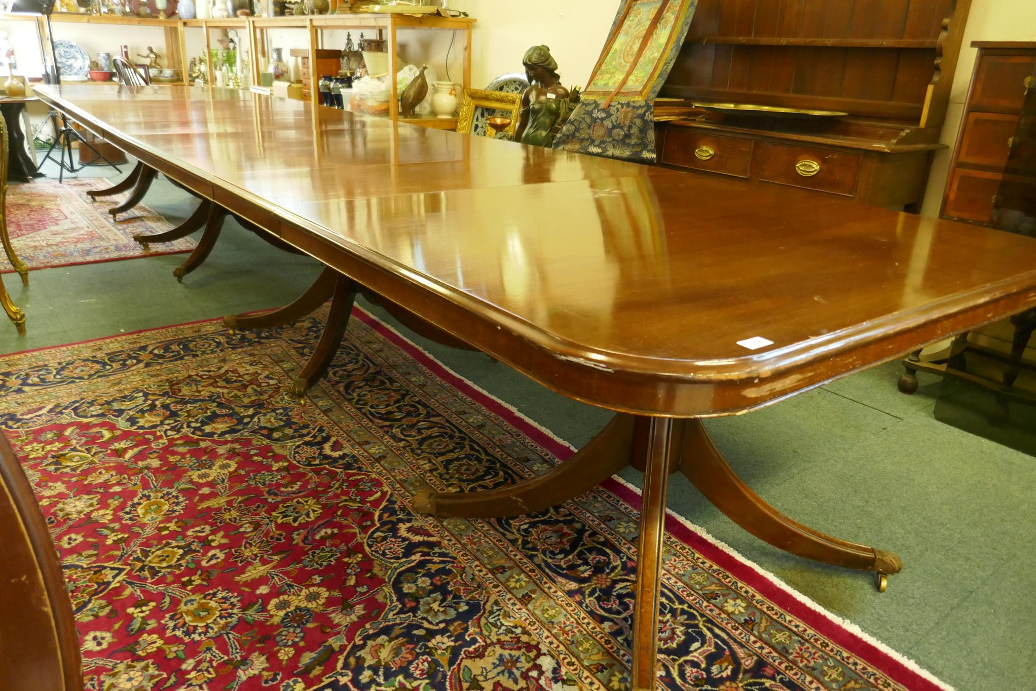 A Regency style mahogany four pedestal dining table with three extra leaves, the solid top with - Image 8 of 9