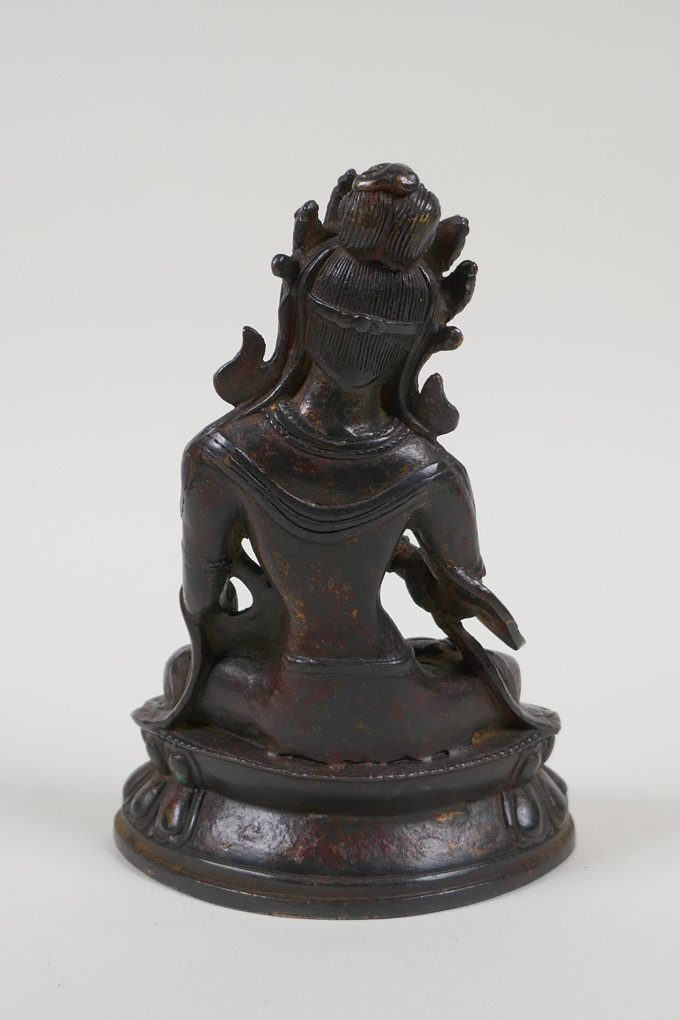 A Sino Tibetan bronze figure of a goddess seated on a lotus throne, 6½" high - Image 4 of 6